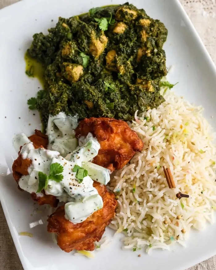 Spinach curry with tikka and rice